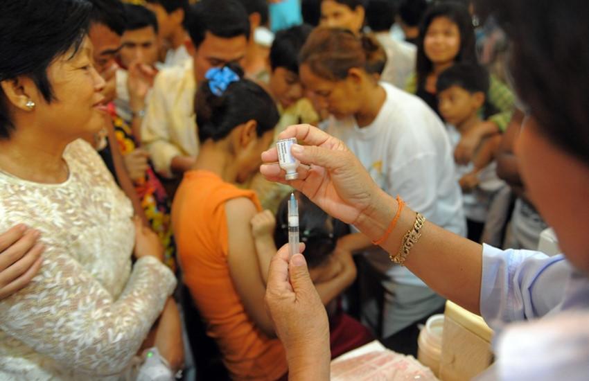 A Cambodian nurse fills her syringe with a vaccine to help protest against influenza A(H1N1), or swine flu, at the Cambodian People's Party headquarters (CPP) in Phnom Penh on July 2, 2010