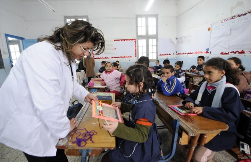 A Tunisian teacher works with her students on March 8, 2011 in Tunis