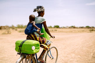 Woman cycling with child