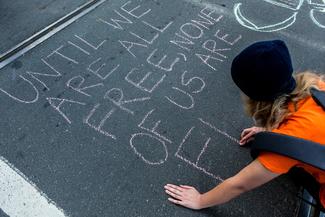 Person writing on the road: human rights day in Australia
