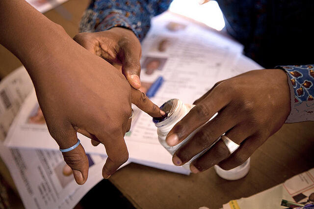 A voter has their finger inked after voting