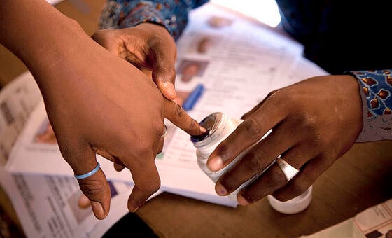 A voter has their finger inked after voting